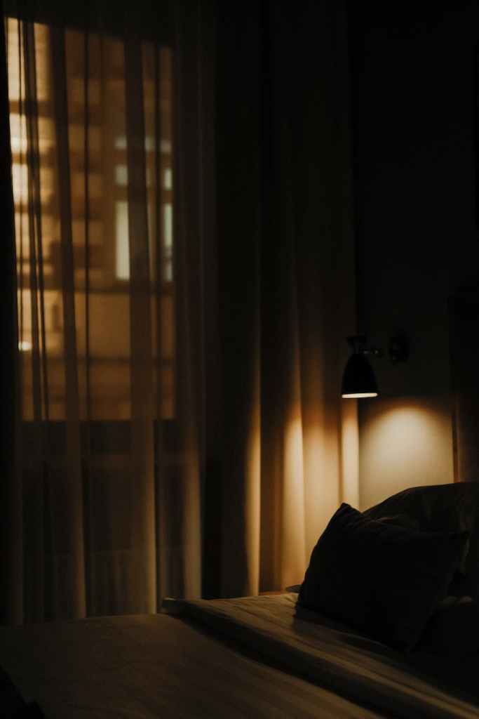 dark hotel room with bedside lamp on - jan vrabec - sparrow's english reader - level 3 english reading for pre-intermediate students